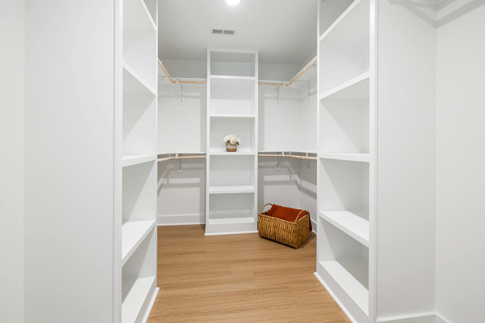 Complete organized linen closet with baskets and shelf dividers