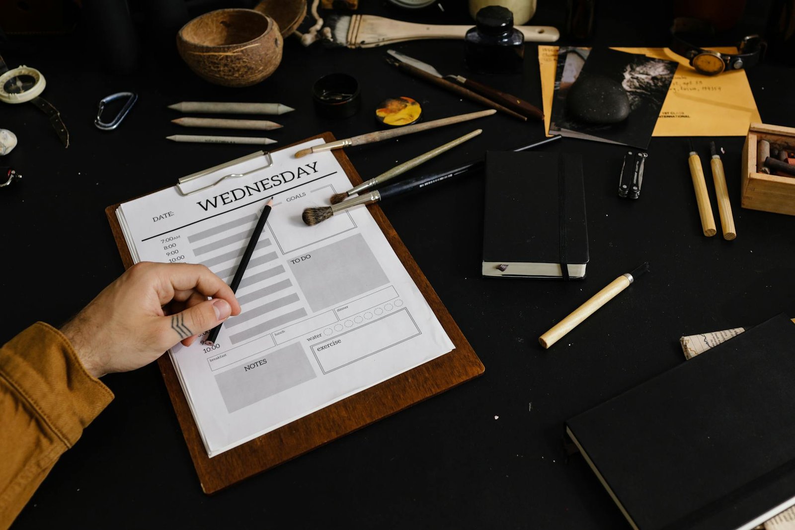 Person organizing papers during weekly paper purge session