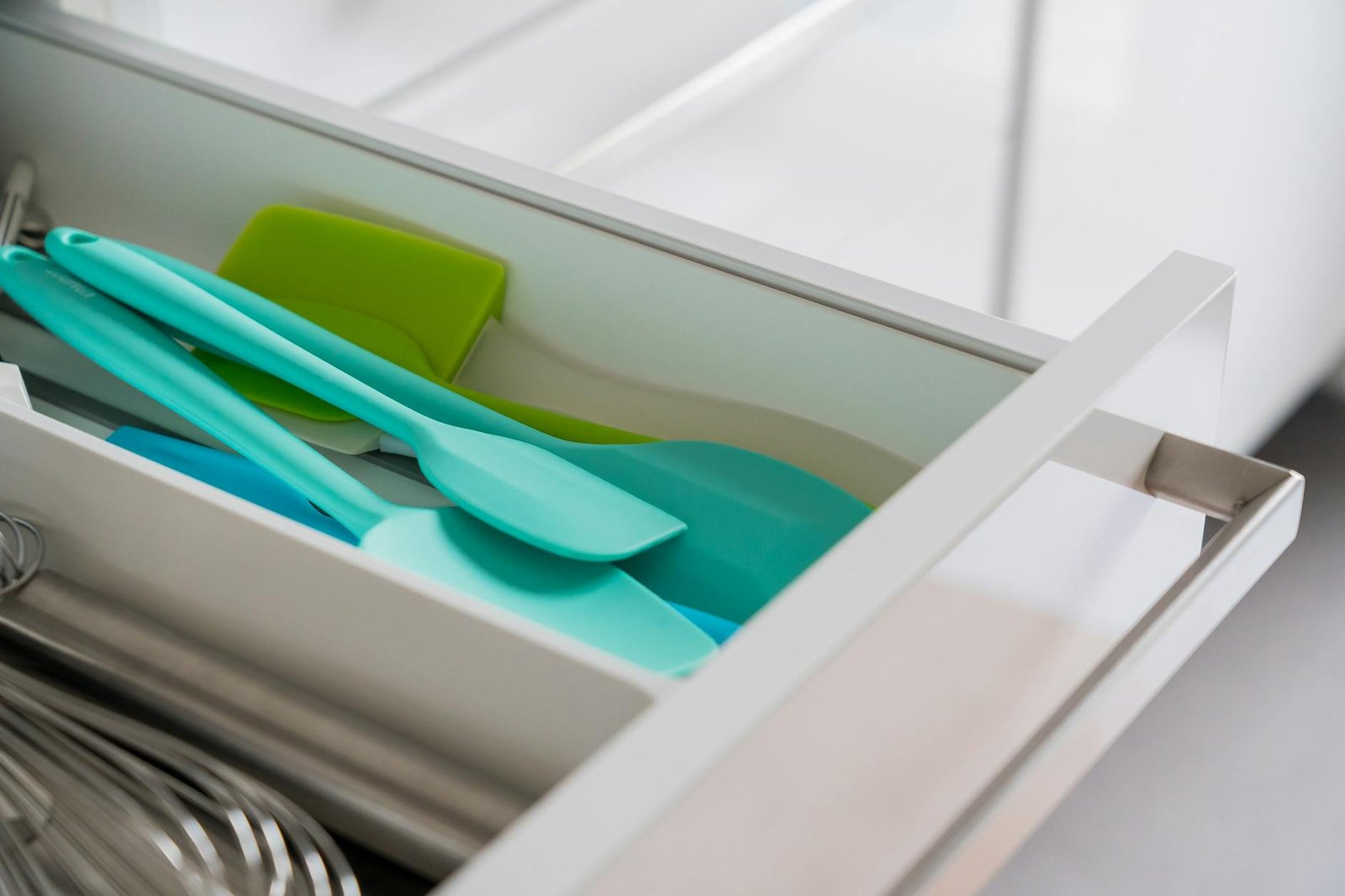 Kitchen drawer with organized baking tools using dividers and nested measuring cups