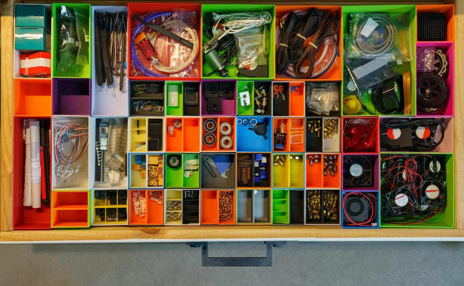 Detailed view of organized junk drawer showing labeled sections and containers