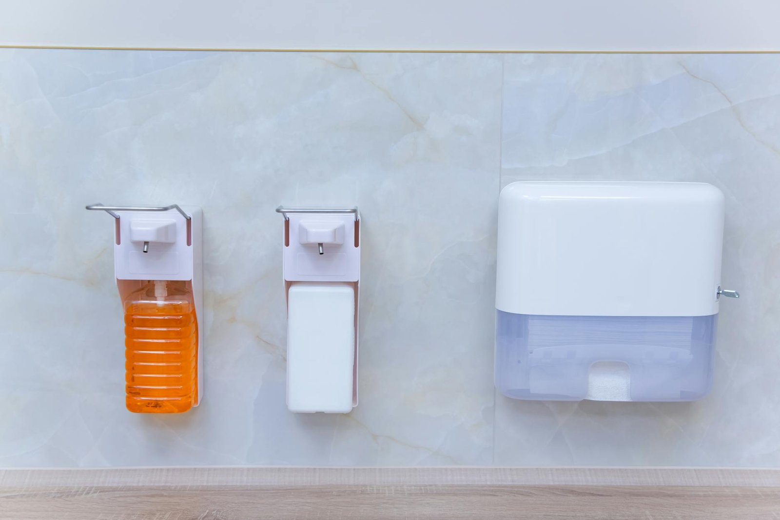 Wall-mounted dispensers for plastic wrap and foil inside cabinet door