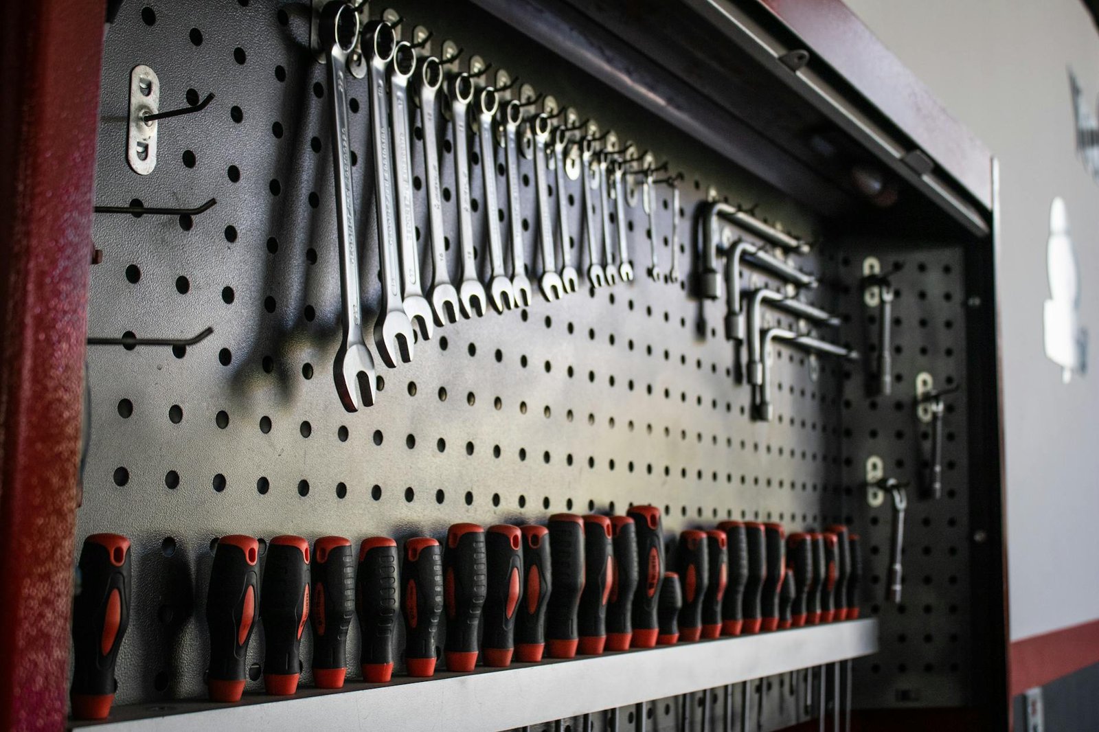 Pegboard tool organization system with magnetic strips and clear storage containers