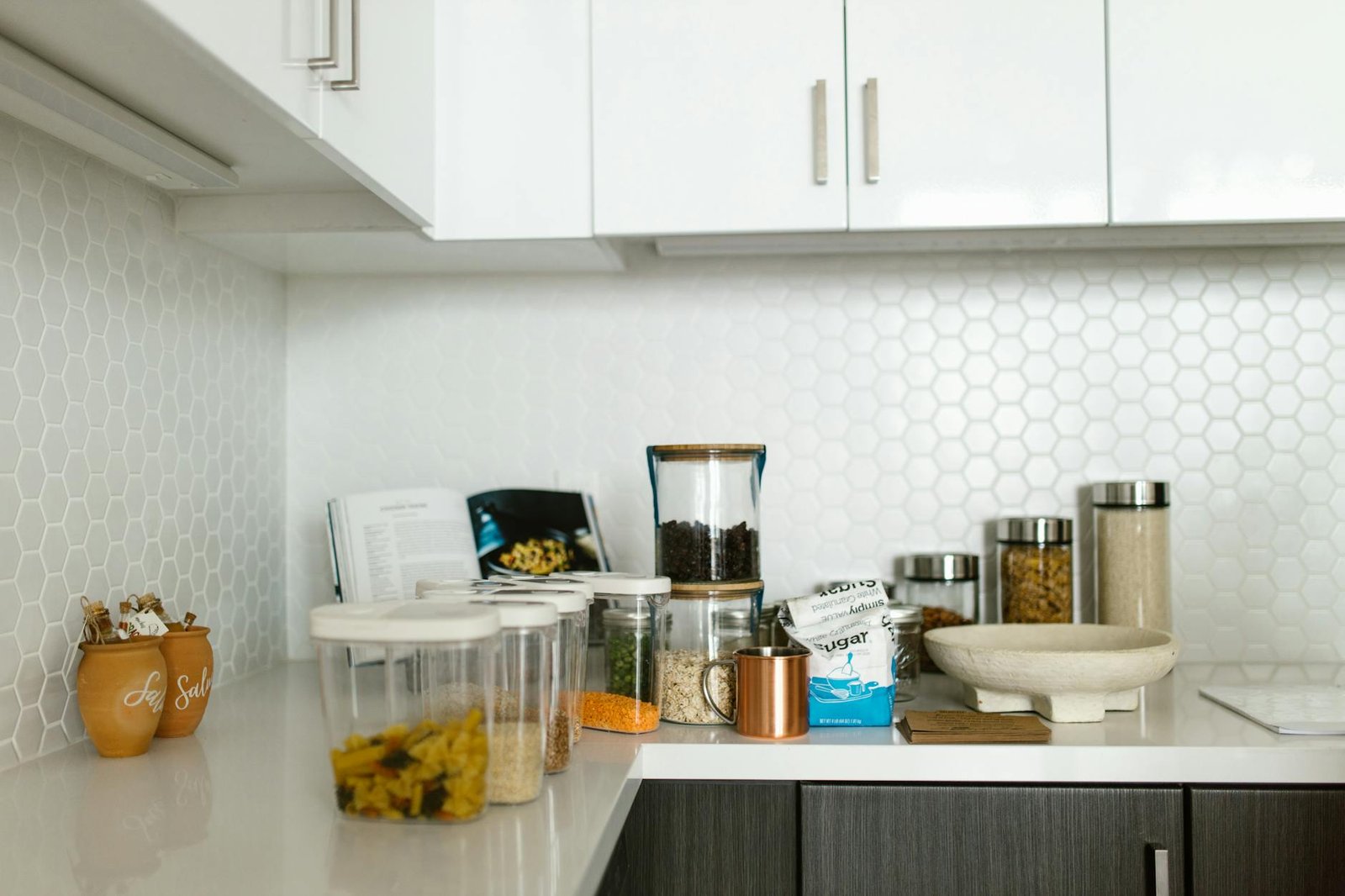 Two-tier lazy susan with organized spice jars in kitchen cabinet