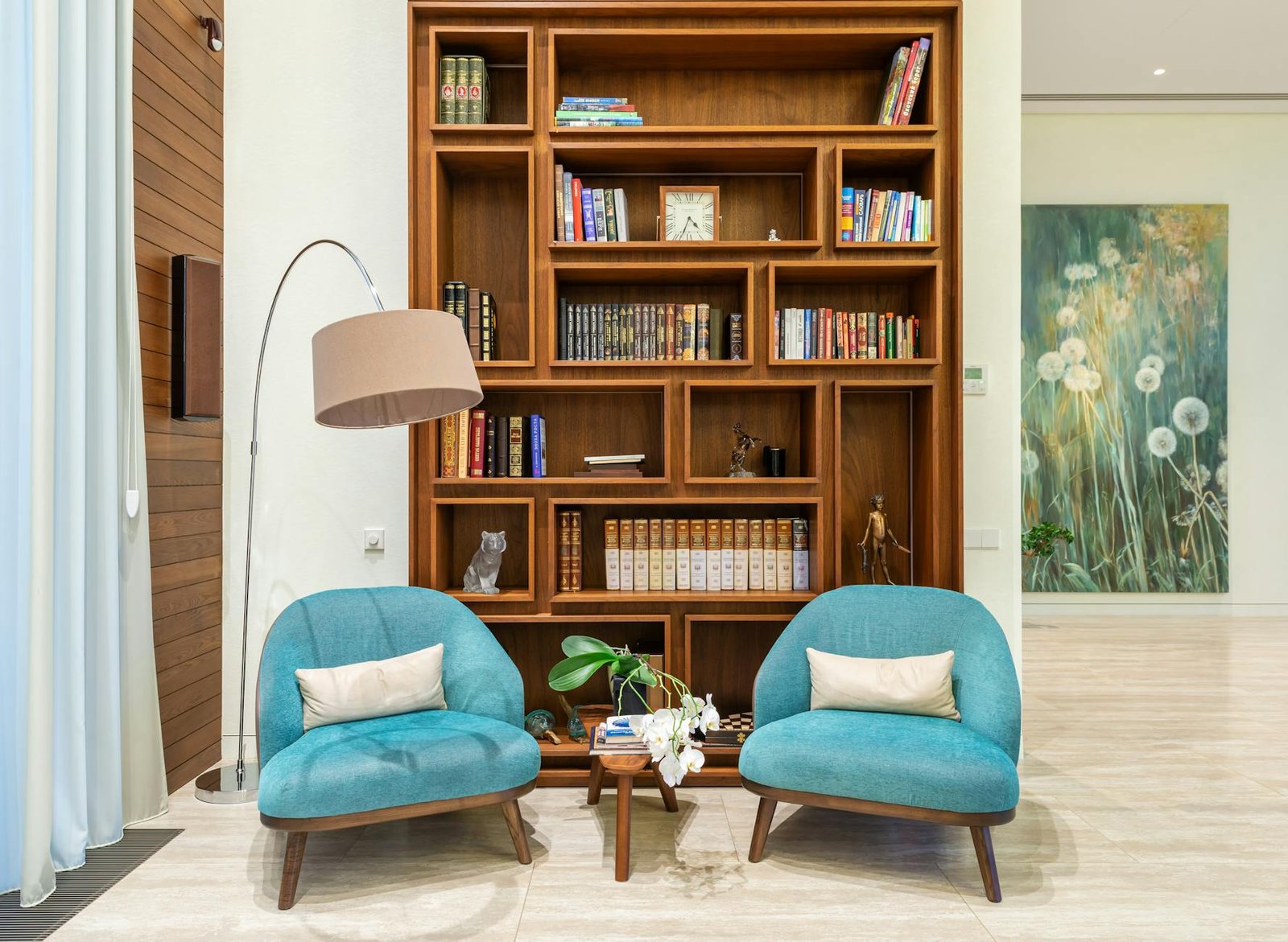 Organized bookshelf and reading nook in living room