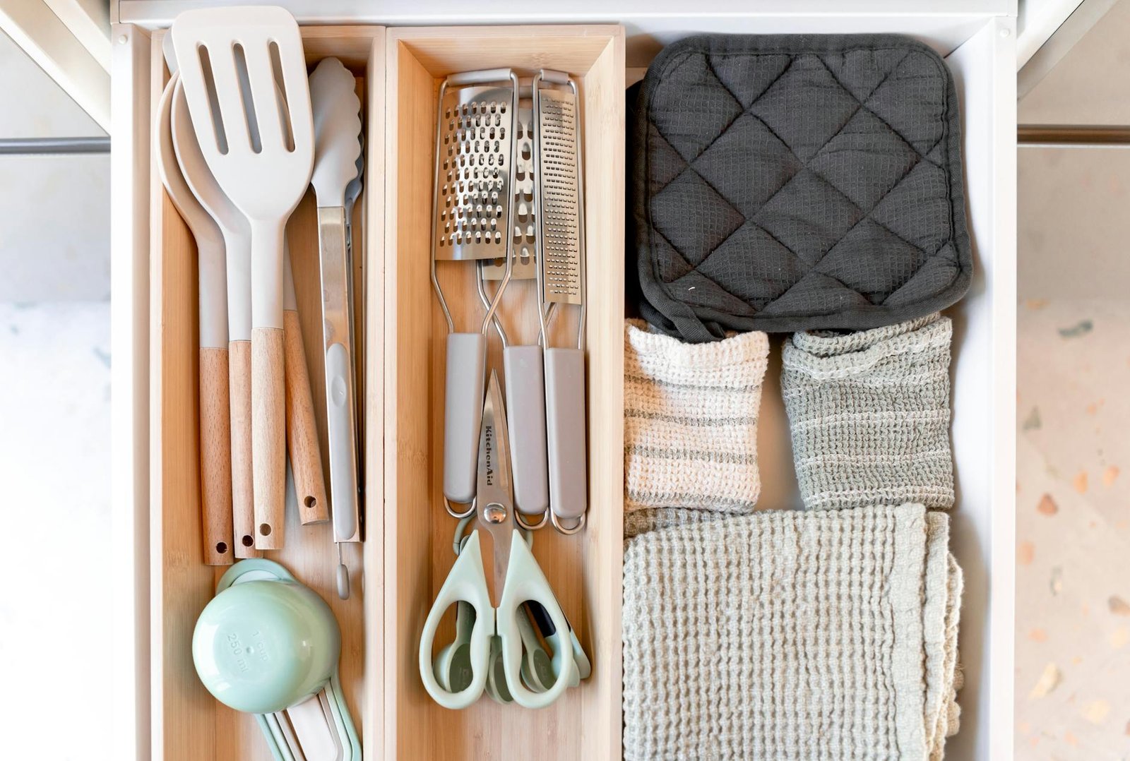 Well-organized kitchen drawer with pot and pan dividers