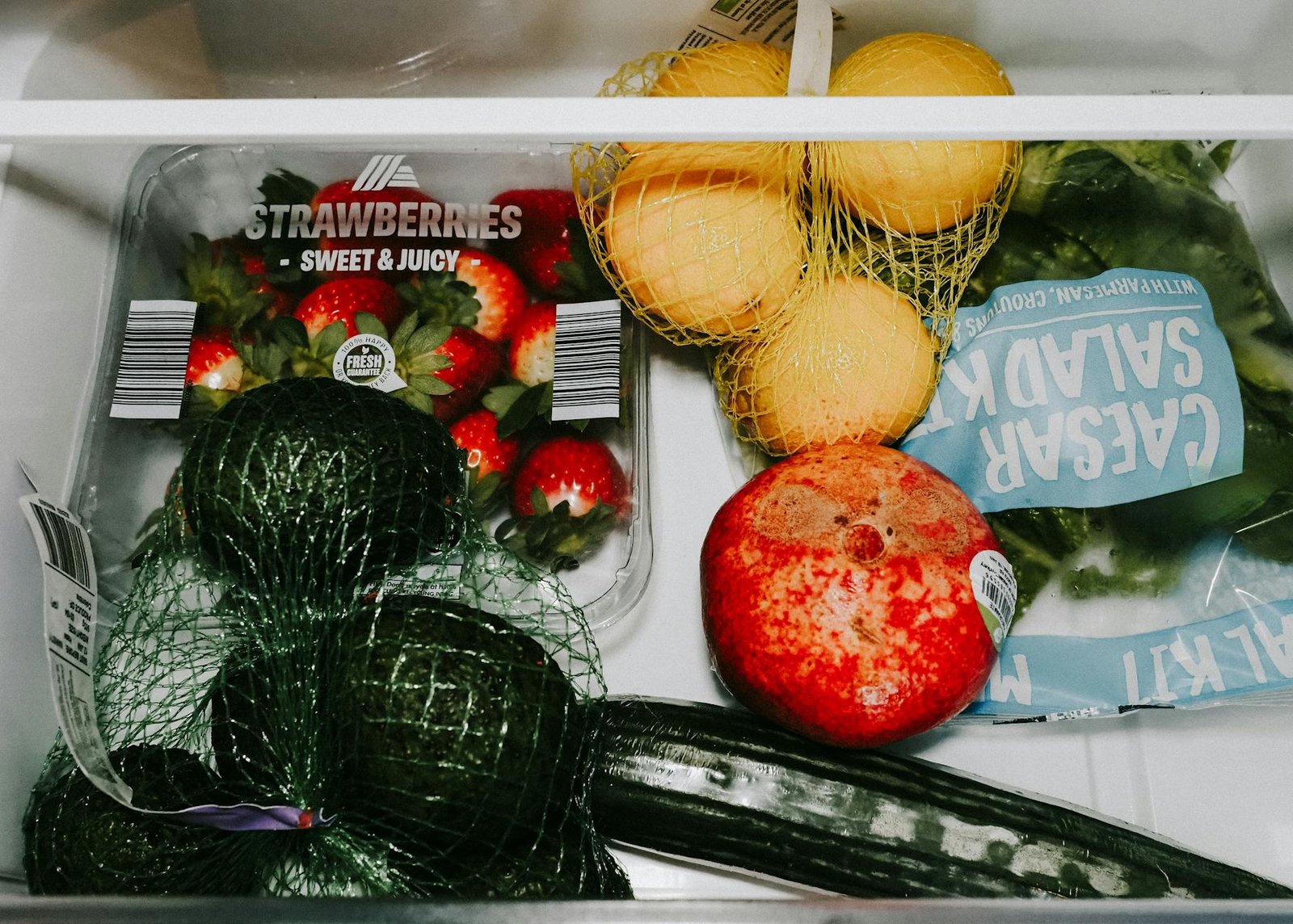 Organized refrigerator drawer with healthy snacks for kids