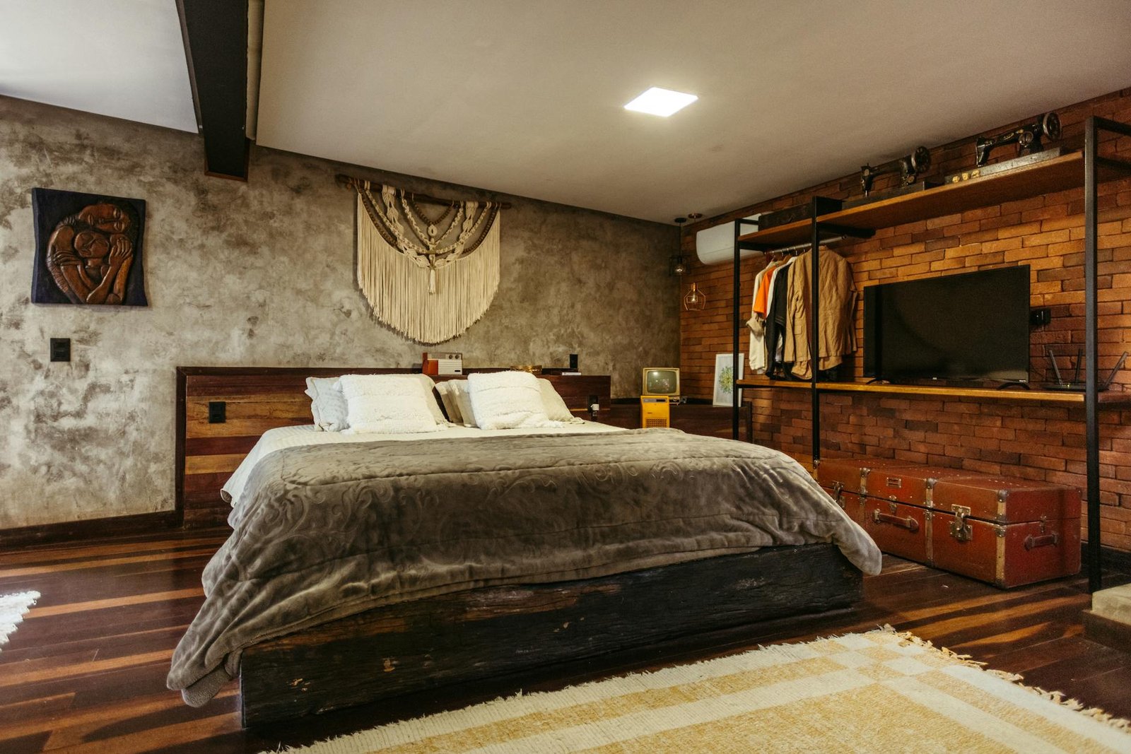 Bedroom corner with creative storage using vintage suitcase nightstand and baskets