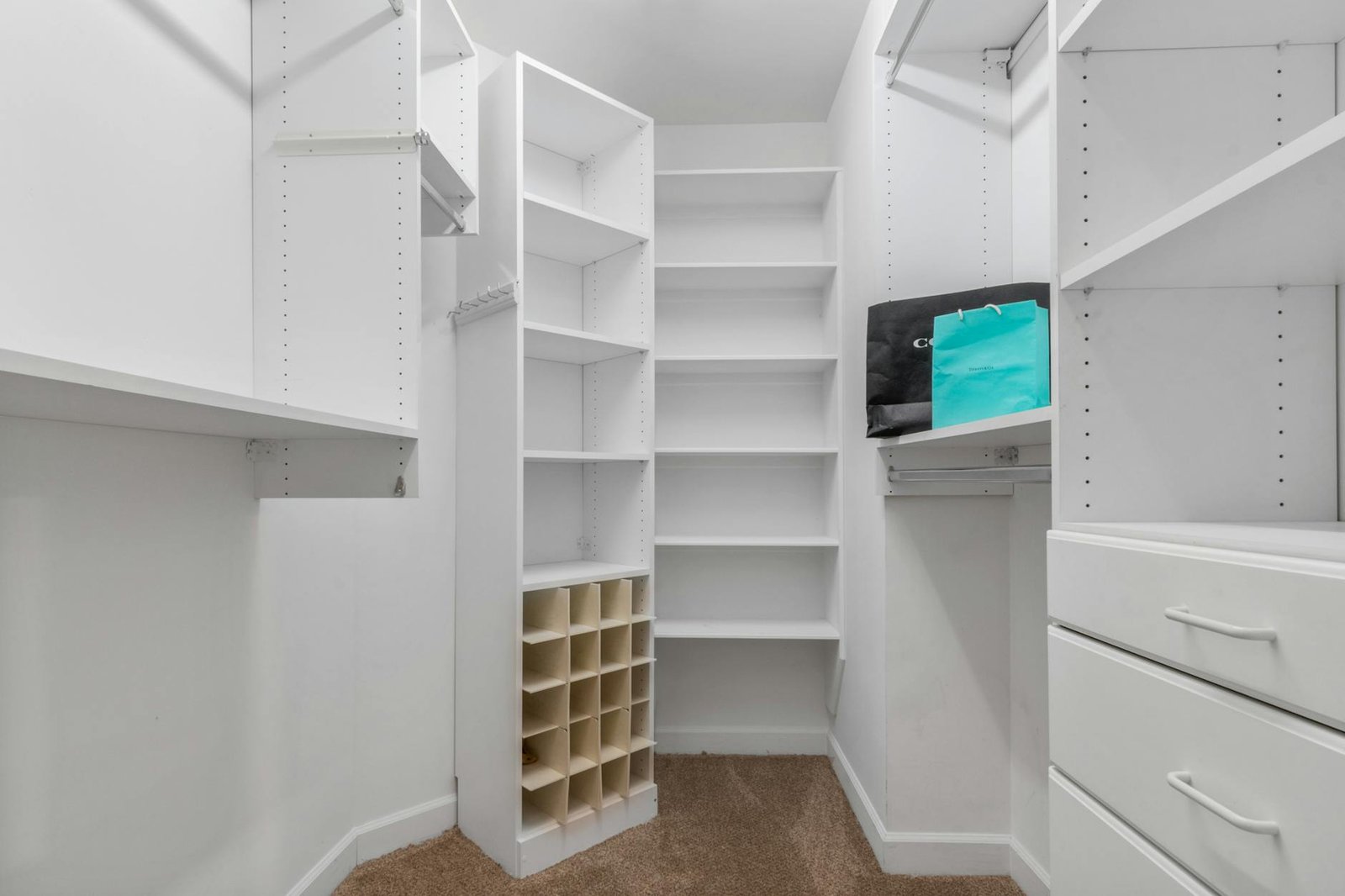 Adjustable wire shelving system organizing clothes and accessories in compact closet space