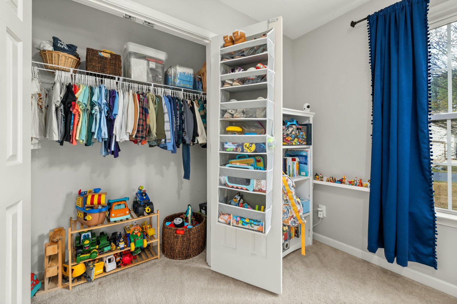 Small closet demonstrating zone organization method with designated areas for different clothing types