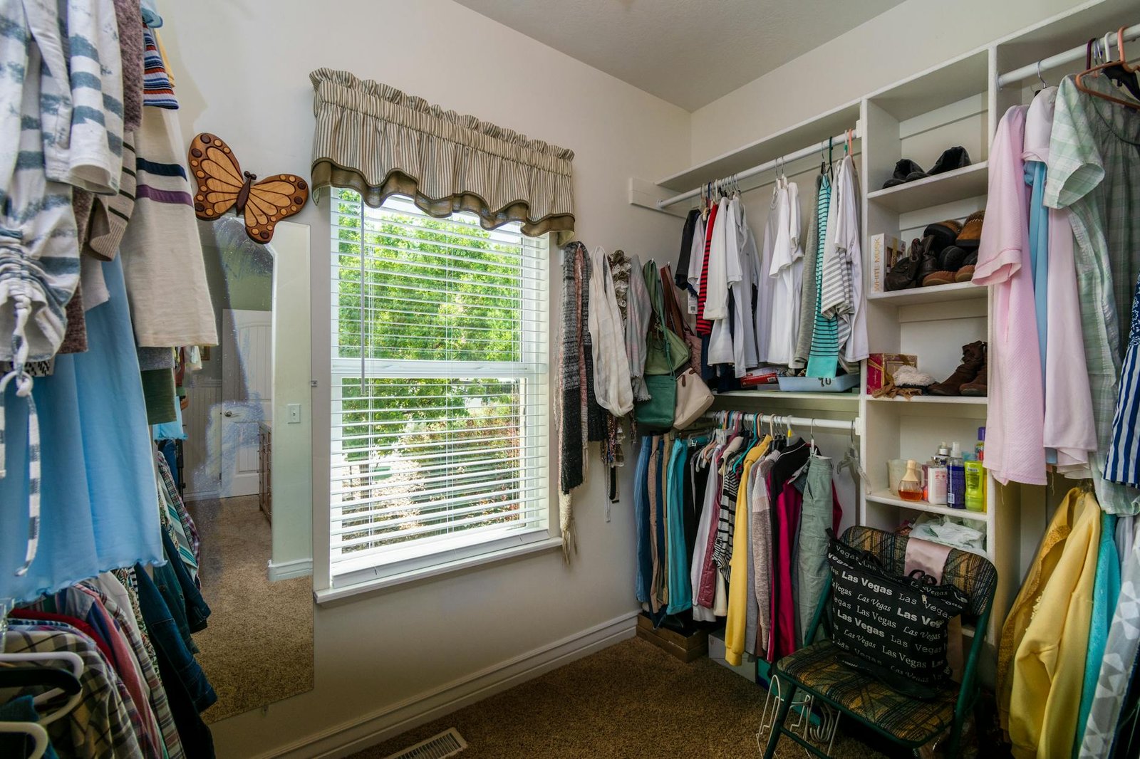 Closet hanging organization system showing capsule wardrobe arranged by category