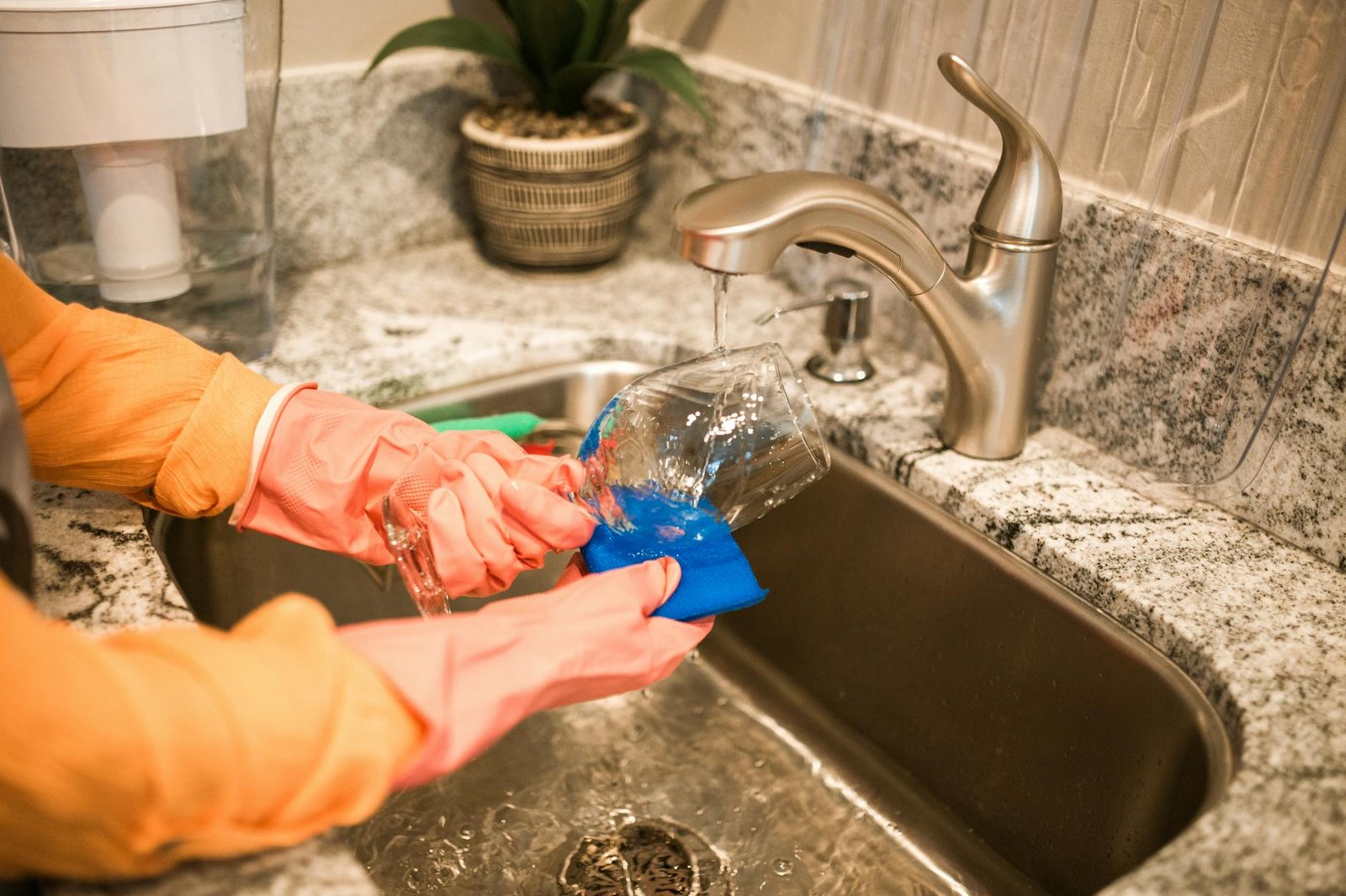 Roll-up dish drying mat over kitchen sink with dishes drying