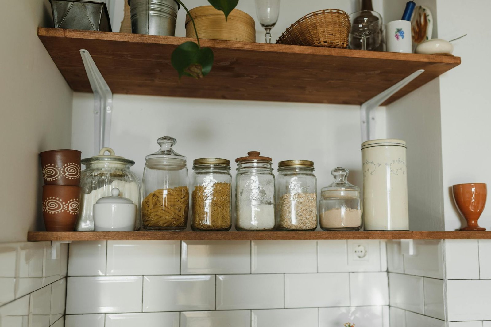 Kitchen shelves with containers and color-coordinated dishes