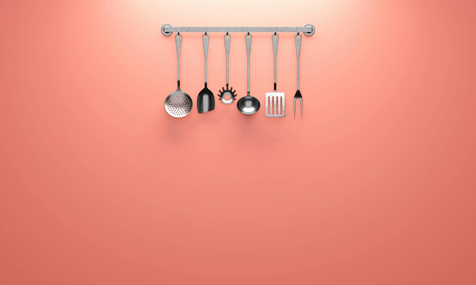 Over-the-door kitchen tool organizer with cooking utensils in clear pockets inside cabinet door