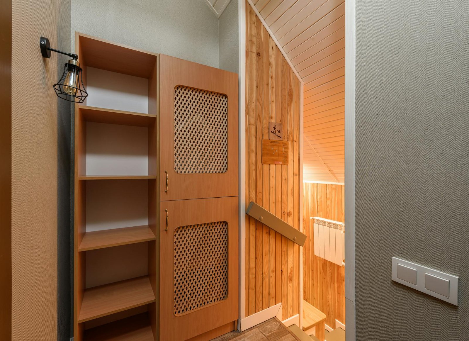Under-stairs closet organized with seasonal clothing storage bins and shelves